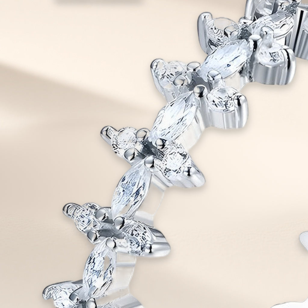 Bague Florilège en gros plan : fleurs de pierres navette et rondes claires, griffes visibles
