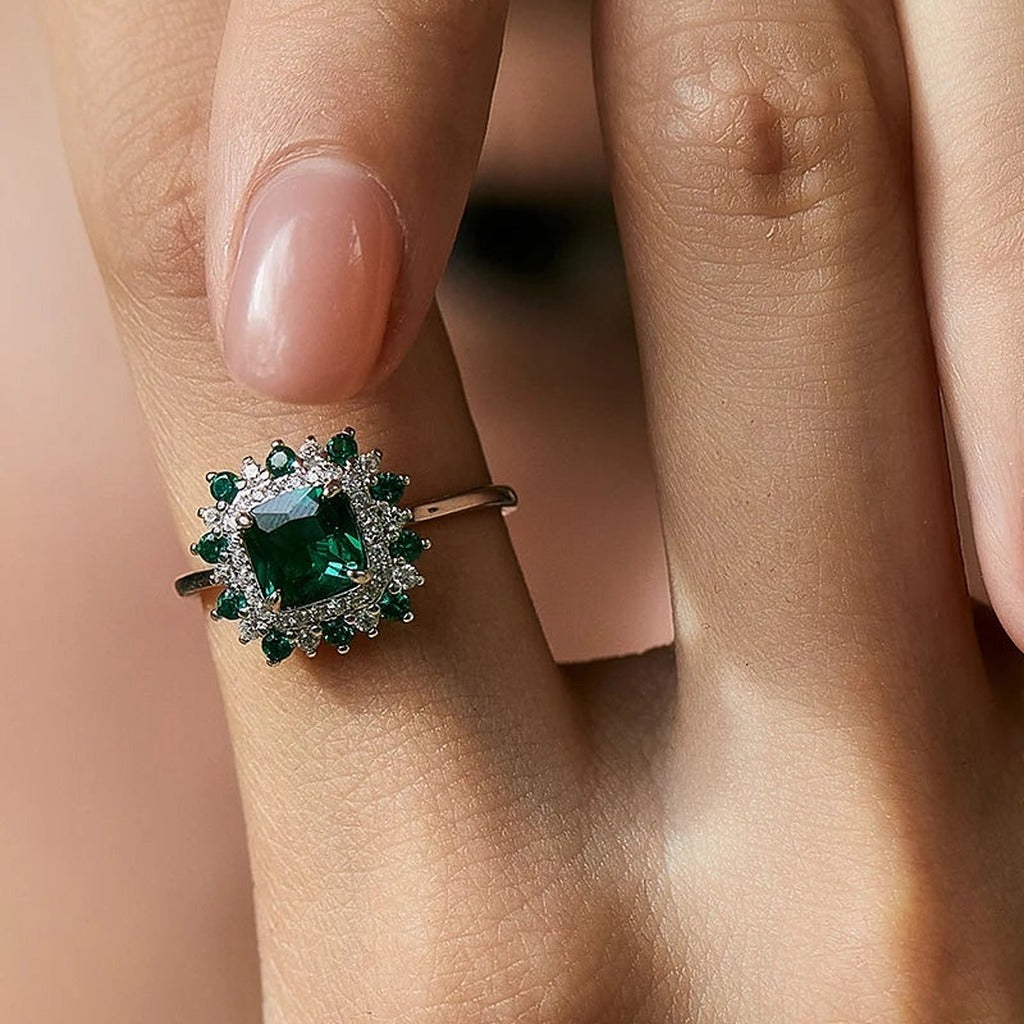 Bague Fleur de Mousse portée au doigt : la fleur de pierres vertes et claires vue de dessus