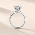 Bague Phare argent 925, modèle 8 mm : moissanite synthétique ronde et incolore tenue haut par six griffes, anneau lisse, sur fond crème