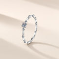 Bague Guirlande en argent 925 à placage de couleur blanche, moissanite synthétique ronde à quatre griffes, anneau en maillons, sur fond crème